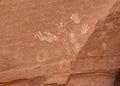 Cliff painting with kokopeli, hand prints, and other symbols Royalty Free Stock Photo