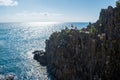 Riomaggiore ITALY - August 2, 2023 - Cliff with people in viewpoint and others swimming in the sea