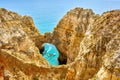 Cliff rocks and sea bay with turquoise water in Lagos, Algarve region, Portugal Royalty Free Stock Photo