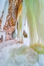 Cliff rocks with sheets of green ice from ground to ceiling Royalty Free Stock Photo