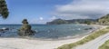 Cliff and sand coast on shore near Kuaotunu, New Zealand Royalty Free Stock Photo