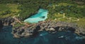 Cliff sea coastline with green landscape, limpid lake on top in aerial view. Scenic tropic seascape Royalty Free Stock Photo