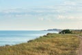 Cliff seascape, town on the horizon