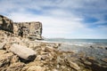 Cliff on spring time with the deep blue sea and sky with clouds Royalty Free Stock Photo