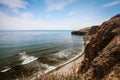 Cliff on spring time with the deep blue sea and sky with clouds Royalty Free Stock Photo