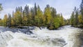 Cliff, stone wall, forest, waterfall and wild river panoramic view in autumn. Fall colors - ruska time in Myllykoski. Royalty Free Stock Photo