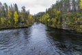 Cliff, stone wall, forest, waterfall and wild river view in autumn. Royalty Free Stock Photo