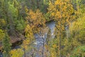 Cliff, stone wall, forest, waterfall and wild river view in autumn. Royalty Free Stock Photo