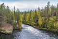 Cliff, stone wall, forest, waterfall and wild river view in autumn. Royalty Free Stock Photo