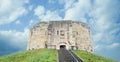 Clifford`s Tower in York, Yorkshire, UK. In a beautiful blue sky Royalty Free Stock Photo