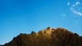 Cliffs against the sky, an old brown mountain peak, bare and rocky, Royalty Free Stock Photo