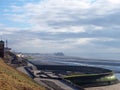 Cliffs area on the south promenade in Blackpool with the beach at low tide with the pier and tower in the distance