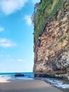 The cliffs on the beach adjoin the water towards the sea