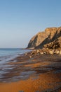 The cliffs and beach at Whale Chine on the Isle of Wight, with a blue sky overhead Royalty Free Stock Photo