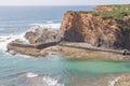 Cliffs, boat and waves in Porto das Barcas, Zambujeira do Mar Royalty Free Stock Photo