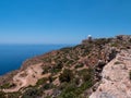 Cliffs Dingli Klippen covered with trees with the sea merging with the sky in the background, Malta Royalty Free Stock Photo