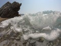 Cliffs, frothy waves lapping on the shore Royalty Free Stock Photo