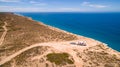 Aerial view of four wheel drive vehicle and caravan parked at The Great Australian Bight on the Edge of the Nullarbor Plain