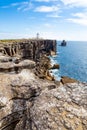 Cliffs and lighthouse of Carvoeiro cape in Peniche Royalty Free Stock Photo