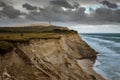 Cliffs in Lonstrup, Rubjerg Knude lighthouse on a dune in the background, north Jutland, Denmark