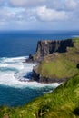Cliffs of Moher at Alantic Ocean in Western Ireland with waves battering against the rocks Royalty Free Stock Photo