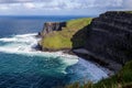 Cliffs of Moher at Alantic Ocean in Western Ireland with waves battering against the rocks Royalty Free Stock Photo