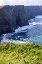 Cliffs of Moher at Alantic Ocean in Western Ireland with waves battering against the rocks Royalty Free Stock Photo