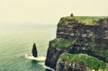 Cliffs of Moher by Atlantic ocean on a foggy, misty day in Ireland Royalty Free Stock Photo