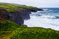 Cliffs of Moher panorama at the Alantic Ocean in Western Ireland with waves battering against the rocks Royalty Free Stock Photo