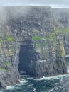 The Cliffs of Moher sea cliffs Ireland with sea cave Royalty Free Stock Photo