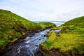 Cliffs of Moher with small creek at Alantic Ocean in Western Ireland with waves battering against the rocks