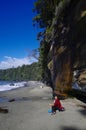 Cliffs overhang the beach where hikers relax