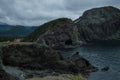Cliffs and Red House along a Rugged Coastline at Lark Harbor in Newfoundland Royalty Free Stock Photo