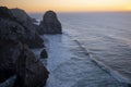 Cliffs and rocks rasing in evening golden sunset light at Atlantic coast of Portugal near famous Cabo Da Roca. Royalty Free Stock Photo