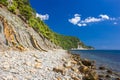 Cliffs, rocks and stones on the seashore on a clear day Royalty Free Stock Photo