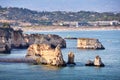 Cliffs of Students beach in the foreground, and Meia beach and Lagos city in the background . Concept of tourism and travel.