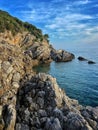 Cliffs surrounding the Adriatic Sea under the blue cloudy sky in Croatia Royalty Free Stock Photo