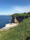 Cliffs ocean pathway to white lighthouse Royalty Free Stock Photo