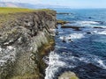 Cliffs washed by waves near gatklettur arch rock in snaefellsjokull