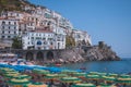 Cliffside houses and beach umbrellas in Amalfi Town, Italy