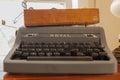Close up view of an antique Royal brand typewriter with a brown wooden box on top.