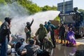 Climate activists from Extinction Rebellion movement blocking the road during protest action, police using water cannon