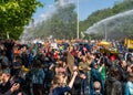 Climate activists from Extinction Rebellion movement blocking the road during protest action, police using water cannon