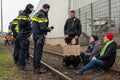 Climate activists in front of the coal train in discussion with police officers during protest against the usage of coal