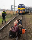 Climate activists sitting in front of the train transporting black coal during protest against the usage of fossil fuels