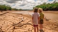 Climate change Children looking at drying river after Drought impact on summer.