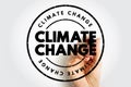 CLIMATE CHANGE circular stamp with distressed edges is shown being drawn by a hand holding a marker. Suitable for environmental Royalty Free Stock Photo
