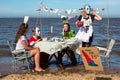 Climate change protestors having a tea party on a beach