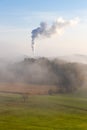 Smoke of carbon dioxide co2 from a chimney of a cement mill / factory pollutes a forest and the whole environment