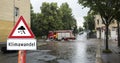 Climate change warning sign flooded roads in german